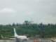 A “green” plane lands as the 737 continues to taxi